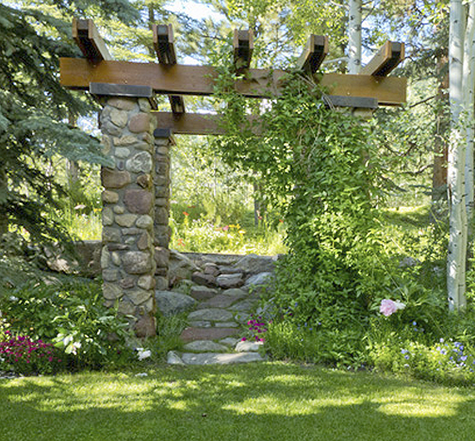 River-boulder trellis An enchanting sitting nook with vines provides shade